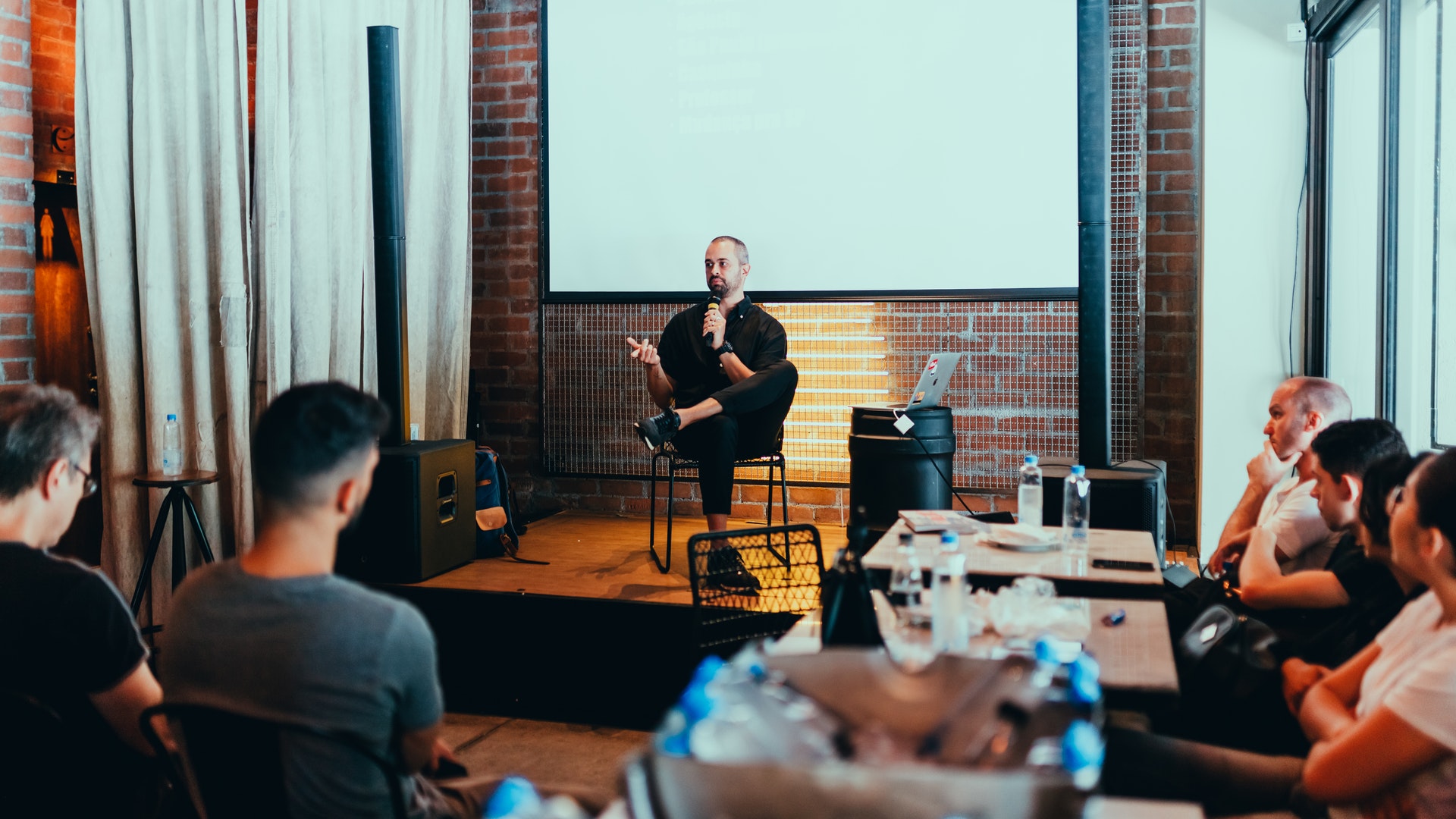 Daniel speaking in front of students